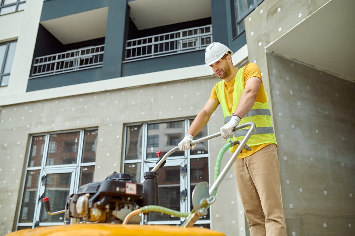 effort-fatigue-young-adult-tired-man-protective-helmet-bright-vest-with-special-equipment-working-construction-site-against-background-new-building (1)